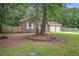 Attractive brick home with a two-car garage, surrounded by mature trees and a well-maintained yard at 110 Terry Ave, Summerville, SC 29485