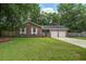 Charming single-story brick home with a well-manicured lawn and two-car garage at 110 Terry Ave, Summerville, SC 29485