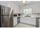 An eat-in kitchen with white cabinets and stainless steel appliances at 110 Terry Ave, Summerville, SC 29485
