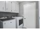 A laundry room with white cabinets and a new washer and dryer at 110 Terry Ave, Summerville, SC 29485