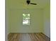 Clean bedroom with ceiling fan, wood-look floors, base molding and bright window at 1101 Stuart Dr, Moncks Corner, SC 29461
