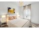 Bright bedroom features a stylish chandelier, neutral decor, and a comfortable bed with decorative pillows at 115 Moscato Ln, Summerville, SC 29485