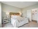 Comfortable bedroom with light green walls, a decorative headboard, and matching nightstands and lamps at 115 Moscato Ln, Summerville, SC 29485