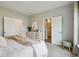 Cozy bedroom with neutral walls, a dresser with a mirror, and doors leading to the closet and bathroom at 115 Moscato Ln, Summerville, SC 29485