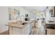 Granite countertops and stainless steel appliances highlight this modern kitchen with an island and dining area at 115 Moscato Ln, Summerville, SC 29485