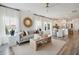 Bright living room with modern decor, large windows, and open floor plan leading to the kitchen at 115 Moscato Ln, Summerville, SC 29485