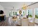 Bright living area with large windows and an open layout connected to the dining area and kitchen at 115 Moscato Ln, Summerville, SC 29485