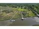 An aerial view shows the home's dock access to the marsh creek and the surrounding neighborhood at 1193 River Rd, Johns Island, SC 29455
