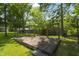 Backyard wood deck nestled among mature trees, offering a private outdoor space at 1193 River Rd, Johns Island, SC 29455