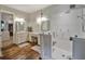 Modern bathroom with dual vanity sinks, marble counters, glass-enclosed shower, and hardwood floors at 1193 River Rd, Johns Island, SC 29455