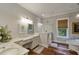 Bright bathroom with dual vanities, marble counters, white tile shower, and standalone tub at 1193 River Rd, Johns Island, SC 29455