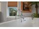 A close-up of the bathtub showing faucet details and window view at 1193 River Rd, Johns Island, SC 29455