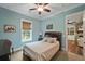 Light-blue bedroom with a window, ceiling fan, and wood floors at 1193 River Rd, Johns Island, SC 29455