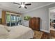 Elegant bedroom with hardwood floors, ceiling fan, and access to screened in back porch at 1193 River Rd, Johns Island, SC 29455