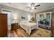 Comfortable bedroom with hardwood floors, natural light, ceiling fan, and porch access at 1193 River Rd, Johns Island, SC 29455
