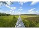 Scenic boardwalk extends over wetlands and leads to tranquil natural beauty at 1193 River Rd, Johns Island, SC 29455
