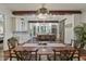 View of the dining room featuring the kitchen in the background with exposed beams and a sliding barn door at 1193 River Rd, Johns Island, SC 29455