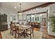 An expansive dining room is seen, featuring a table, chairs, and an open view into the modern kitchen space at 1193 River Rd, Johns Island, SC 29455