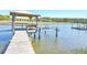 Waterfront dock featuring a covered gazebo and a boat lift on a sunny day at 1193 River Rd, Johns Island, SC 29455