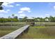 Waterfront dock with a covered gazebo surrounded by marshland on a clear day at 1193 River Rd, Johns Island, SC 29455