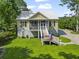 Classic two-story home featuring lush green lawns and complemented by the surrounding mature trees at 1193 River Rd, Johns Island, SC 29455