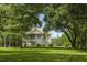 Lovely two-story home surrounded by lush greenery and a well-maintained lawn, creating a serene setting at 1193 River Rd, Johns Island, SC 29455