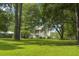 Charming two-story home featuring mature trees, a lush green lawn, and a welcoming, classic architectural design at 1193 River Rd, Johns Island, SC 29455