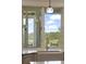 Kitchen window framing a serene outdoor view of a river, trees, and a peaceful sky at 1193 River Rd, Johns Island, SC 29455