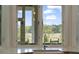 Charming kitchen window view of a waterway and wooded area, inviting natural light into the space at 1193 River Rd, Johns Island, SC 29455