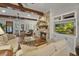 Bright living room featuring stone fireplace, hardwood floors, and comfortable sofas at 1193 River Rd, Johns Island, SC 29455