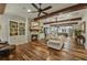 Inviting living room showcasing stone fireplace, built-in bookcase and hardwood flooring throughout at 1193 River Rd, Johns Island, SC 29455