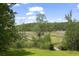 Expansive marsh view from backyard featuring a long wooden walkway and vibrant green lawn at 1193 River Rd, Johns Island, SC 29455