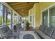 Relax on this screened porch, featuring cozy seating, beautiful views, and providing the perfect spot for outdoor enjoyment at 1193 River Rd, Johns Island, SC 29455