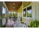 Relax on this screened porch, featuring cozy seating, beautiful views, and providing the perfect spot for outdoor enjoyment at 1193 River Rd, Johns Island, SC 29455