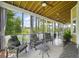 Relax on this screened porch, featuring cozy seating, beautiful views, and providing the perfect spot for outdoor enjoyment at 1193 River Rd, Johns Island, SC 29455