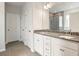 Modern bathroom showcasing a dual vanity with granite countertops and tiled floors at 124 Palfrey Dr, Ridgeville, SC 29472