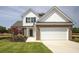 Charming two-story home featuring a brick and siding facade, well-manicured lawn, and an attached two-car garage at 124 Palfrey Dr, Ridgeville, SC 29472