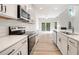 Modern kitchen featuring white cabinets, stainless steel appliances, and hardwood floors with an open concept layout at 124 Palfrey Dr, Ridgeville, SC 29472