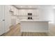 Modern kitchen with white cabinets, stainless steel appliances, a center island, and hardwood floors at 124 Palfrey Dr, Ridgeville, SC 29472
