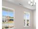 Bright and airy living room featuring large windows offering scenic outdoor views and modern interior design at 124 Palfrey Dr, Ridgeville, SC 29472