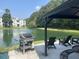 Inviting patio with grill and seating overlooking the serene pond and community at 1300 Park West Blvd # 822, Mount Pleasant, SC 29466