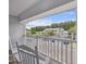 Charming balcony featuring white rocking chairs and a beautiful view of the complex at 1300 Park West Blvd # 822, Mount Pleasant, SC 29466