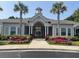 Beautiful clubhouse exterior featuring palm trees and colorful landscaping at 1300 Park West Blvd # 822, Mount Pleasant, SC 29466