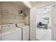 Laundry closet with washer, dryer, and wire shelving; adjacent to the bedroom and office at 1300 Park West Blvd # 822, Mount Pleasant, SC 29466