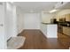 Open living room with wood floors and view to the kitchen with stainless steel appliances at 1300 Park West Blvd # 822, Mount Pleasant, SC 29466