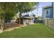 Backyard with large tree, green grass, screen porch, and fenced yard at 1368 Little David Court Ct, Charleston, SC 29412