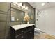 Green toned bathroom with white subway tile shower and black fixtures at 1368 Little David Court Ct, Charleston, SC 29412