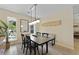 Inviting dining room with hardwood floors, modern light fixture and large windows at 1368 Little David Court Ct, Charleston, SC 29412
