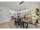Open concept dining room with modern light fixture, hardwood floors and kitchen view at 1368 Little David Court Ct, Charleston, SC 29412