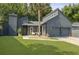 Charming modern home with gray siding, a two-car garage and a beautiful palm tree in the front yard at 1368 Little David Court Ct, Charleston, SC 29412